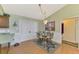 Cozy dining area featuring a glass table, four chairs, chandelier, and a decorative rug at 1137 Ponderosa Rd, Venice, FL 34293
