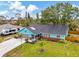 Inviting light blue home featuring manicured front lawn, tidy landscaping, and an attached two car garage at 1137 Ponderosa Rd, Venice, FL 34293