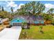 Aerial view of the home showcasing the well-maintained lawn, driveway, and landscaping at 1137 Ponderosa Rd, Venice, FL 34293