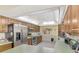Kitchen with stainless steel refrigerator and oven, wooden cabinets and a decorative ceiling at 1137 Ponderosa Rd, Venice, FL 34293