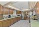 Traditional-style kitchen with wood cabinets, tile flooring, and ample counter space at 1137 Ponderosa Rd, Venice, FL 34293