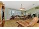 Cozy living room with comfortable seating, a bay window, and a large entertainment center at 1137 Ponderosa Rd, Venice, FL 34293