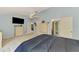 Spacious main bedroom with blue walls, a ceiling fan, and multiple closets and doorways at 1137 Ponderosa Rd, Venice, FL 34293