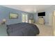 Bedroom featuring blue walls, white trim, and French doors to the exterior at 1137 Ponderosa Rd, Venice, FL 34293