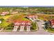 Beautiful aerial view of the townhome community with lush landscaping and a scenic pond at 1156 Jonah Dr, North Port, FL 34289