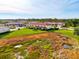 Aerial view of community featuring well-manicured lawn and pond for peaceful living at 1156 Jonah Dr, North Port, FL 34289