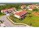 Scenic aerial shot of townhomes featuring screened in lanai, surrounded by lush landscaping and green lawns at 1156 Jonah Dr, North Port, FL 34289