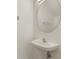 White pedestal sink in well-lit powder room with round mirror at 1156 Jonah Dr, North Port, FL 34289