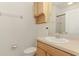 Standard bathroom with wood cabinets, white sink, toilet, and a mirror above the sink at 1156 Jonah Dr, North Port, FL 34289