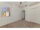 Large bedroom with carpet, ceiling fan, and white walls, door leading to an open closet at 1156 Jonah Dr, North Port, FL 34289