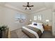 Bright bedroom featuring a ceiling fan, neutral decor, and a large window that lets in natural light at 1156 Jonah Dr, North Port, FL 34289