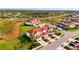 Aerial view of community featuring homes with red tile roofs, lush lawns, and palm trees at 1156 Jonah Dr, North Port, FL 34289