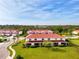 Beautiful exterior view of a multi-Gathering home with red tile roof and lush green lawn at 1156 Jonah Dr, North Port, FL 34289