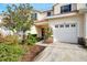 Charming home exterior with lush landscaping, a private garage, and a welcoming entrance at 1156 Jonah Dr, North Port, FL 34289