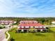 A view of the townhome featuring screened lanais, a red tile roof, and well-maintained lawn at 1156 Jonah Dr, North Port, FL 34289