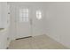 Bright foyer featuring tile floors and a round accent window for natural light at 1156 Jonah Dr, North Port, FL 34289