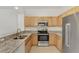Bright kitchen features granite counters, stainless steel appliances and wood cabinetry at 1156 Jonah Dr, North Port, FL 34289