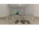 Close up view of a kitchen sink, with a view of the living room and lanai in the background at 1156 Jonah Dr, North Port, FL 34289
