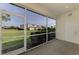 Screened-in lanai providing serene views of the surrounding lush lawn and community buildings at 1156 Jonah Dr, North Port, FL 34289