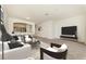 Virtual staged: Bright living room area with carpet and a view of the kitchen at 1156 Jonah Dr, North Port, FL 34289