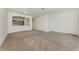 Open-concept living room with carpet flooring, white walls, and kitchen view at 1156 Jonah Dr, North Port, FL 34289