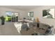 Living room, decorated with modern furniture, sliding glass door to lanai, and an open dining area at 1156 Jonah Dr, North Port, FL 34289