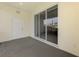 Covered lanai with sliding glass doors overlooks green space at 1156 Jonah Dr, North Port, FL 34289