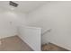 Well-lit stairwell with carpeted steps and white walls at 1156 Jonah Dr, North Port, FL 34289