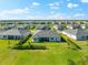 A well-maintained home sits in a lakefront community surrounded by manicured lawns and lush landscaping at 17336 Sandpearl Rd, Venice, FL 34293