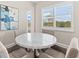 Bright dining area featuring a round marble table, four chairs, and natural light from the window at 17336 Sandpearl Rd, Venice, FL 34293