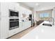 Well-equipped kitchen with stainless steel appliances, quartz countertops, and ample cabinet space at 17336 Sandpearl Rd, Venice, FL 34293