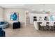 Bright open-concept living area showcasing stylish decor, wood-look flooring, and a modern aesthetic at 17336 Sandpearl Rd, Venice, FL 34293