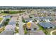 Aerial view of a single-story home in a waterfront community with manicured lawns and mature palm trees at 1751 Nottingham Trl, Punta Gorda, FL 33980