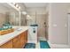 Bathroom featuring a walk-in shower with tile surround and sleek fixtures at 1751 Nottingham Trl, Punta Gorda, FL 33980