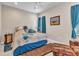 Bright bedroom featuring a cozy sitting area, bedside table, and a comfortable queen-sized bed at 1751 Nottingham Trl, Punta Gorda, FL 33980