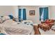 Bright bedroom featuring a cozy sitting area, soft carpet, and a comfortable queen-sized bed at 1751 Nottingham Trl, Punta Gorda, FL 33980