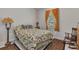 Cozy bedroom with a comfortable queen-sized bed, rocking chair, and soft, natural light at 1751 Nottingham Trl, Punta Gorda, FL 33980