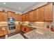 Modern kitchen with stainless steel appliances, granite countertops, and ample cabinet space at 1751 Nottingham Trl, Punta Gorda, FL 33980