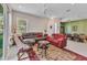 Bright living room featuring neutral walls, a ceiling fan, and a comfortable seating arrangement with a large rug at 1751 Nottingham Trl, Punta Gorda, FL 33980