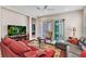 Comfortable living room with a large sofa, sliding doors, and views of the outside at 1751 Nottingham Trl, Punta Gorda, FL 33980