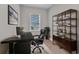 Home office with a sleek black desk, comfortable leather chair, and ample shelving at 1751 Nottingham Trl, Punta Gorda, FL 33980