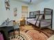 This is a bedroom with a bunkbed, piano, and uniquely patterned rug at 18396 Laramie Ave, Port Charlotte, FL 33954