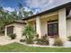 Home entrance with double front doors, decorative glass, and a beautiful garden bed at 18396 Laramie Ave, Port Charlotte, FL 33954