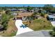 Aerial shot of the property showing its canal-front location, mature trees, and palm tree driveway design at 18584 Alphonse Cir, Port Charlotte, FL 33948