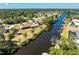 Aerial view of a waterfront home on a canal with a boat dock and lush landscaping at 18584 Alphonse Cir, Port Charlotte, FL 33948