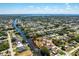Wide aerial view of a waterfront community with many canals homes and open water views at 18584 Alphonse Cir, Port Charlotte, FL 33948