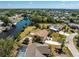 Aerial view showcasing a waterfront property with lush landscaping and canal access at 18584 Alphonse Cir, Port Charlotte, FL 33948
