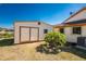 Backyard shed with double doors, set against blue skies and lush landscape at 18584 Alphonse Cir, Port Charlotte, FL 33948