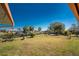 Large grassy backyard with a chainlink fence and canal view beyond with mature trees, and room for outdoor activities at 18584 Alphonse Cir, Port Charlotte, FL 33948