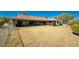 Expansive grassy backyard with a chainlink fence surrounding the perimeter, with a jacuzzi and patios at 18584 Alphonse Cir, Port Charlotte, FL 33948